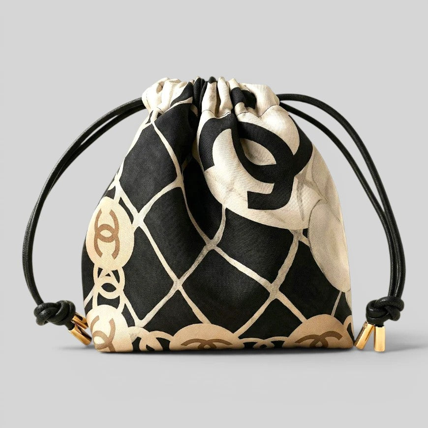 Prettysac black and cream patterned drawstring pouch with gold chain accents and black leather cords.