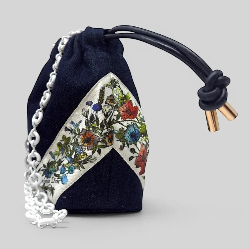Prettysac Christian Dior dark wash denim drawstring pouch with floral print and white chain strap.