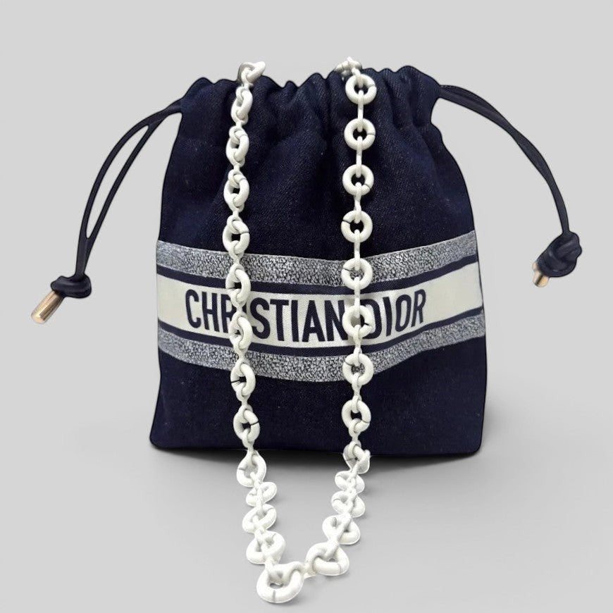 Prettysac Christian Dior dark denim drawstring pouch with white logo band and chunky white chain strap.