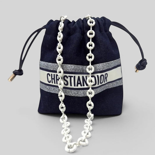 Prettysac Christian Dior dark denim drawstring pouch with white logo band and chunky white chain strap.