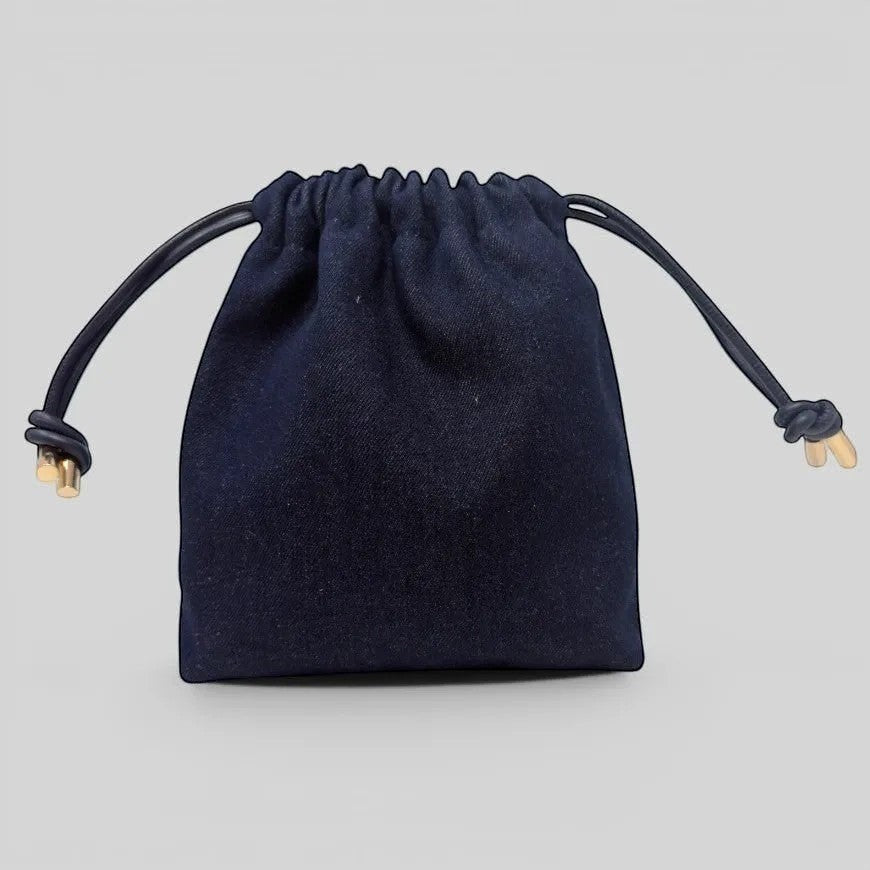 Prettysac dark wash denim drawstring pouch with gold hardware and leather ties. Features a floral print.