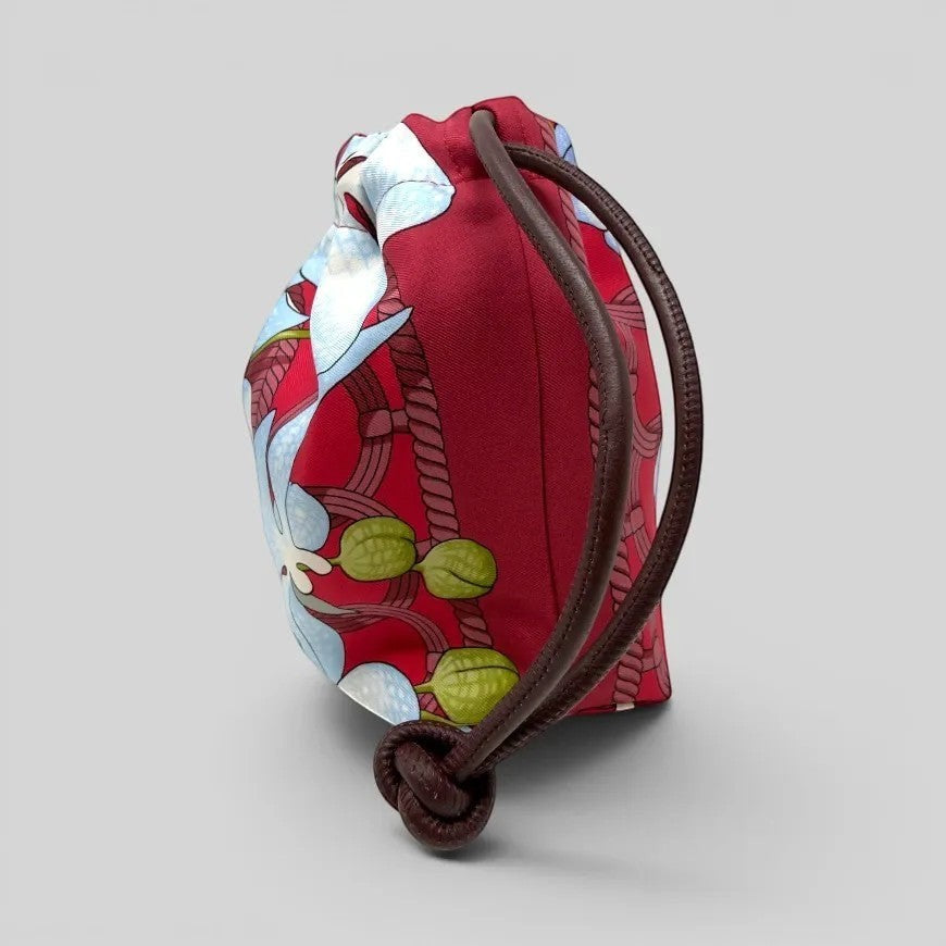 Prettysac Souvenirs D'Asie drawstring pouch with floral print in red, sky blue, white, crimson, and green. Features leather cords.