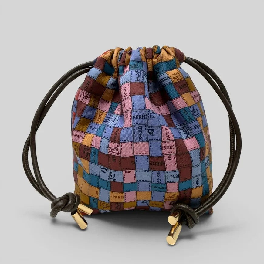 Prettysac artisanal patchwork pouch with dark brown leather drawstring and gold-tone hardware, featuring rich colours and iconic motifs.