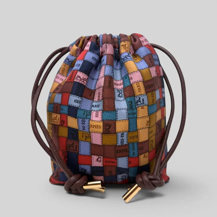 Prettysac artisanal patchwork pouch with leather drawstring and gold-tone hardware, featuring a colourful scarf print.